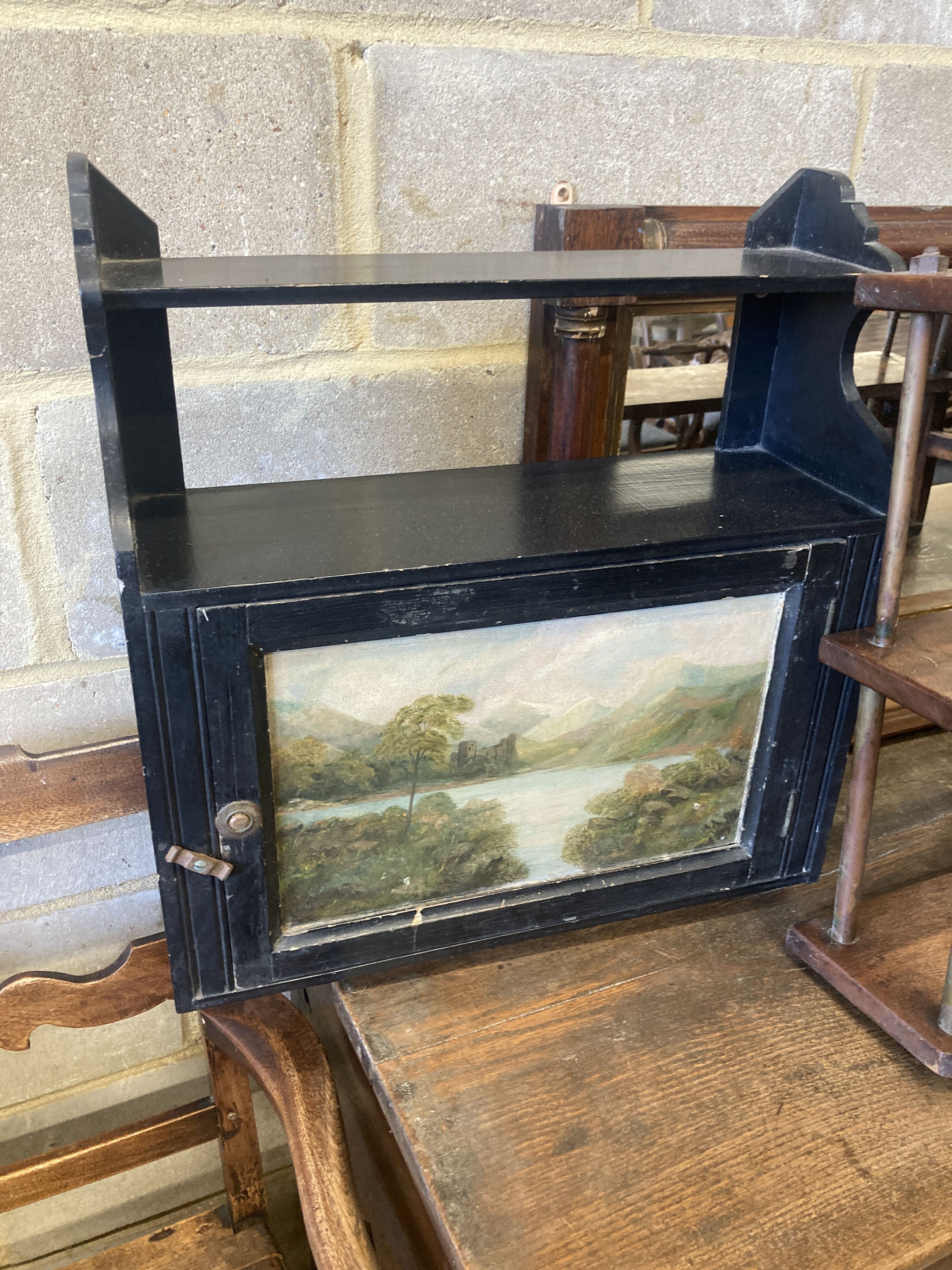 A late Victorian wall cabinet painted with a landscape scene, width 47cm, pair of provincial wood seat chairs, a mahogany three tier wall shelf and a Victorian overmantel mirror